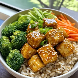- 1 block firm tofu, drained and pressed - 3 tablespoons honey - 3 tablespoons soy sauce - 2 tablespoons sesame oil I love using firm tofu for this dish. It absorbs the flavors well and holds its shape. Honey adds a sweet touch. Soy sauce gives a salty, umami kick. Sesame oil adds a nutty depth to the mix. - 1 cup steamed broccoli florets - 1 small carrot, julienned - 1 tablespoon sesame seeds - 2 green onions, sliced For veggies, I choose broccoli. It’s bright and crisp, full of nutrients. Carrots add a nice crunch and a pop of color. Sesame seeds and green onions bring extra flavor and texture. They make the dish look great, too. - 2 garlic cloves, minced - 1 teaspoon fresh ginger, grated - Salt and pepper to taste Garlic and ginger are key players here. They pack a punch of flavor and warmth. I use salt and pepper to balance everything out. These ingredients tie the whole dish together, making it truly special. Start by draining the tofu. Wrap it in a clean towel. Place a heavy plate on top. This helps to remove excess water. Let it sit for about 15 minutes. After that, cut the tofu into small cubes. Aim for about one-inch pieces. This size helps them cook evenly. Now, let’s make the marinade. In a bowl, mix together honey, soy sauce, sesame oil, minced garlic, and grated ginger. Stir until all ingredients blend well. This marinade adds great flavor to the tofu. Next, add the cubed tofu to the marinade. Make sure each piece gets coated. Let it sit for at least 30 minutes. For best results, place it in the fridge. After marinating, heat a skillet over medium heat. Add a splash of sesame oil. Once hot, carefully add the tofu cubes. Reserve the marinade for later use. Fry the tofu for about 4-5 minutes on each side. You want them golden brown and crispy. Then, pour in the reserved marinade. Let everything simmer for another 2-3 minutes. This thickens the sauce and makes it stick to the tofu. Now it’s time to assemble the bowls. Start with a layer of cooked brown rice. This serves as a nice base. Next, add in steamed broccoli and julienned carrots on top. Finally, place the honey garlic sesame tofu over the veggies. For a finishing touch, sprinkle sesame seeds and sliced green onions on top. You can also add salt and pepper to taste. Enjoy your tasty, colorful bowl! Tofu needs a great texture for this dish. Use firm tofu. Press it well to remove excess water. This helps the tofu soak up flavors. Cut the tofu into bite-sized cubes. Marinate them for at least 30 minutes. You can even leave them in the fridge overnight for more flavor. You can add more spices to boost taste. Try red pepper flakes for heat. A dash of smoked paprika adds a nice twist. If you want a different sweetener, use maple syrup. Agave nectar works well too. Both can replace honey without losing flavor. Pair your bowl with sauces for extra zest. A drizzle of sriracha brings spice. Try a sesame dressing for more depth. For toppings, add sliced avocado or chopped nuts. These add creaminess and crunch. Don’t forget to sprinkle more sesame seeds for a nutty touch! {{image_2}} You can easily make this recipe vegan. Just swap honey with maple syrup or agave nectar. This keeps the sweetness without using animal products. For protein, you can use tempeh or chickpeas. Both options are tasty and keep the meal filling. Change the base to fit your taste. Quinoa or rice noodles add a different texture. You can also add more veggies. Try bell peppers, snap peas, or even cabbage for crunch. This way, you can keep the meal exciting and colorful. Want a kick? Add some grated ginger or crushed red pepper for heat. You can also include citrus. A squeeze of lime or lemon juice brightens the dish. This adds freshness and balances the sweetness of the honey. To keep your honey garlic sesame tofu bowls fresh, follow these tips: - Refrigeration: Place leftovers in an airtight container. They last for 3-4 days in the fridge. - Storing Separately: Keep tofu, rice, and veggies in different containers. This helps maintain texture and flavor. - Storing Together: If you combine everything, eat it within 2 days for best taste. To reheat your tofu bowls without losing texture, try these steps: - For Tofu: Heat in a skillet over medium heat. Cook for 3-4 minutes until warm. - Microwave: If using a microwave, place tofu on a plate. Cover with a damp paper towel. Heat for 1-2 minutes. - Maintaining Texture: Avoid overcooking. This keeps tofu crispy and veggies bright. Preparing your meals ahead can save time and effort. Here are some tips: - Prepare in Advance: Marinate tofu the night before. This enhances flavor and saves time. - Keep Components Fresh: Store rice and veggies in the fridge. Cook rice just before eating for the best taste. - Batch Cooking: Make large amounts of tofu and rice. Freeze portions for quick meals later. Yes, you can use different types of tofu in this recipe. Firm tofu works best because it holds its shape when cooked. Soft or silken tofu may break apart, making it tricky to fry. Extra-firm tofu is also a great choice. It gives a nice texture and absorbs flavors well. Just remember to drain and press any tofu you use. This step helps remove excess moisture, allowing for a perfect crisp. Yes, this recipe can be gluten-free. Regular soy sauce contains gluten, but you can use tamari instead. Tamari is a gluten-free soy sauce that offers a similar taste. Make sure to check labels when buying. Some brands also make gluten-free honey sauces. These can add flavor without gluten. Always double-check ingredients to keep your meal safe and tasty. You can store Honey Garlic Sesame Tofu Bowls in the fridge for up to three days. Keep the tofu and rice separate from the veggies if you can. This helps maintain their textures. When you’re ready to eat, reheat in a skillet or microwave. Make sure the tofu is heated through. Enjoy your meal fresh for the best flavor! This guide covered the key ingredients for a tasty tofu bowl. We looked at how to prepare the tofu and make a flavorful marinade. Cooking steps and assembly turned out simple and fun. I shared tips for perfecting your tofu and adding extra flavor. With various options and meal prep advice, you can create a dish that lasts. Experiment with different ingredients for your own twist. Enjoy the process, and make it your own!