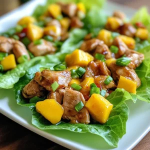 - 1 lb (450g) boneless, skinless chicken breasts, diced - 1 ripe mango, diced - 1 red bell pepper, finely chopped - 2 green onions, sliced - 2 garlic cloves, minced - 1 tablespoon ginger, grated - 2 tablespoons soy sauce - 1 tablespoon honey - 1 tablespoon sriracha sauce - 1 tablespoon sesame oil - 1 tablespoon lime juice - Chopped cilantro for garnish - Salt and pepper The main ingredients in this dish create a balance of sweet and spicy. I love using boneless, skinless chicken breasts for their tenderness. Dicing the chicken allows it to cook quickly and soak up all the flavors from the marinade. The ripe mango adds a fruity touch, making each bite delightful. The red bell pepper brings crunch, and the green onions add a fresh kick. Garlic and ginger round out the flavor profile. Together, these ingredients create a fresh, vibrant dish. For the marinade, the soy sauce gives depth, while honey adds sweetness. Sriracha provides heat, and sesame oil adds a nutty flavor. Lime juice brightens everything up. This mix is key to making the chicken flavorful and juicy. If you want to elevate your wraps, consider adding chopped cilantro. This optional garnish adds freshness. Don’t forget to season with salt and pepper to taste. It’s simple, but it makes a big difference in flavor. {{ingredient_image_1}} To start, we need to marinate the chicken. In a medium bowl, combine the diced chicken with soy sauce, honey, sriracha, sesame oil, garlic, and ginger. Mix everything well so the chicken gets a nice coat. It's best to let this marinate for at least 30 minutes in the fridge. This time allows the flavors to soak into the chicken, making it tasty. Next, heat a non-stick skillet over medium-high heat. Add the marinated chicken to the skillet. Cook the chicken for about 6 to 8 minutes. You'll know it's done when it turns golden brown and is fully cooked. Stir it often to ensure even cooking and a nice caramelization. This step is key for that sweet and spicy flavor. Once the chicken is cooked, it’s time to add some color and crunch. Toss in the chopped red bell pepper and sauté for about 2 to 3 minutes. This makes the bell pepper tender but still crisp. After that, remove the skillet from the heat. Gently fold in the diced mango and sliced green onions. This adds a fresh taste and brightens up the dish. Adjust the seasoning with salt and pepper to your liking. Now, you're ready to prepare the lettuce wraps! To get the right spice level, start with sriracha. Add a little at first. Taste your mix before adding more. This way, you control the heat. Spice can be strong, so adjust slowly. Mango brings sweetness, balancing the heat. The mix of sweet and spicy makes the dish shine. To keep chicken moist, avoid overcooking. Use a timer to check cooking time. Cook the chicken in a hot skillet. This helps it brown nicely. You can also bake it in the oven. If you choose the oven, set it to 375°F. Bake the chicken for about 20-25 minutes. To make this dish even better, add more spices. Consider cumin or paprika for depth. Cooking with fresh herbs, like cilantro, boosts flavor too. Also, try marinating longer for richer taste. Letting the chicken sit in the marinade overnight works wonders. The longer you let the flavors blend, the tastier your meal will be. Pro Tips Marinate Longer for Flavor: For an even more flavorful chicken, consider marinating for 1-2 hours or overnight if time allows. This will enhance the taste and tenderness. Fresh Ingredients Matter: Use fresh, ripe mango for the best flavor. A perfectly ripe mango will add a natural sweetness that complements the spice of the chicken. Spice Level Adjustments: Feel free to adjust the amount of sriracha to suit your personal heat preference. You can also add chopped jalapeños for an extra kick! Crisp Lettuce Leaves: For the best texture, choose crisp lettuce leaves and rinse them in cold water before serving. This will help keep them fresh and crunchy. {{image_2}} You can swap chicken for other proteins. Tofu works well for a vegetarian option. Shrimp adds a nice seafood twist. Both choices keep the dish tasty and fun. For gluten-free diets, look for gluten-free soy sauce. This simple switch ensures everyone can enjoy the meal. Mixing in tropical fruits can enhance flavors. Pineapple adds sweetness, while papaya brings a fresh taste. Try different sauce mixes too. A sweet chili sauce can add a great kick. You can also play with spices like cumin or coriander for a unique twist. If you want to change the wraps, try collard greens or rice paper. These options give new textures and flavors. You can also serve the wraps with side dishes. Rice or a simple salad complements the meal well. This way, you can create a full meal experience. To keep your spicy mango chicken fresh, use airtight containers. Glass containers work well since they don't stain. You can also use plastic containers, but ensure they seal tightly. Store the leftovers in the fridge for up to three days. It’s best to keep the chicken mixture separate from the lettuce. This helps prevent sogginess. When reheating chicken, the best method is the stovetop. Heat a pan over medium heat. Add a splash of water or broth to keep it moist. Stir it gently until warmed through. Avoid the microwave if you can. Microwaving can dry out the chicken and make it tough. You can freeze the chicken mixture if you have extra. Place it in a freezer-safe bag. Squeeze out the air before sealing. It can last up to three months in the freezer. When you’re ready to eat, thaw it overnight in the fridge. Reheat using the stovetop method for the best texture. Butter lettuce and romaine are both great choices. Butter lettuce has soft, tender leaves. It holds fillings well and adds a light crunch. Romaine offers a sturdier texture, making it less likely to tear. If you want a more crisp bite, choose romaine. For a softer wrap, butter lettuce is the way to go. You can even mix them for fun textures! Yes, you can prepare parts of this dish ahead of time. I suggest marinating the chicken the day before. This allows the flavors to blend well. You can also chop veggies in advance and store them in the fridge. When you are ready to eat, cook the chicken and mix in the veggies. This keeps everything fresh and tasty. Scaling up is easy! Just multiply each ingredient by the number of servings you need. For example, if you want to serve eight, use two pounds of chicken and two mangoes. Keep the sauce ratios the same to maintain flavor. Make sure to use a larger skillet for cooking, so everything cooks evenly. Enjoy the fun of cooking for a crowd! This blog post covers a delicious recipe featuring chicken, mango, and vibrant veggies. You learned how to marinate the chicken for maximum flavor and cook it perfectly. We explored tips for adjusting spice levels, variations for dietary needs, and storage methods. You can enjoy this dish in many ways, making it versatile for any meal. Try different fruit or sauce combos to suit your taste. With simple steps and fresh ingredients, this recipe will make your dinner exciting and tasty. Enjoy your cooking journey!